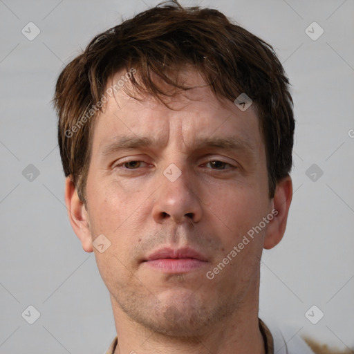 Neutral white adult male with short  brown hair and grey eyes