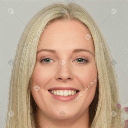 Joyful white young-adult female with long  blond hair and blue eyes