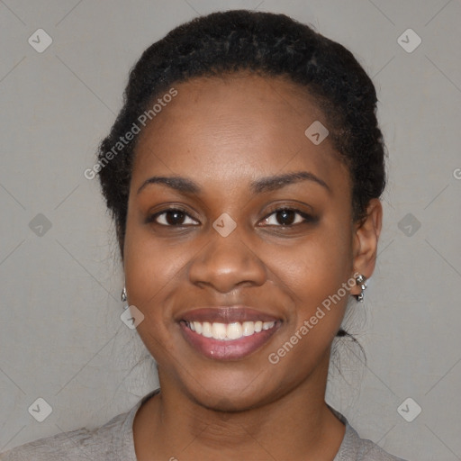 Joyful black young-adult female with short  black hair and brown eyes