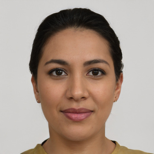 Joyful latino young-adult female with short  brown hair and brown eyes