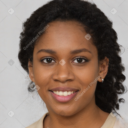 Joyful black young-adult female with long  black hair and brown eyes