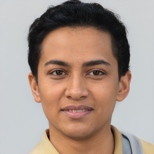 Joyful latino young-adult male with short  brown hair and brown eyes
