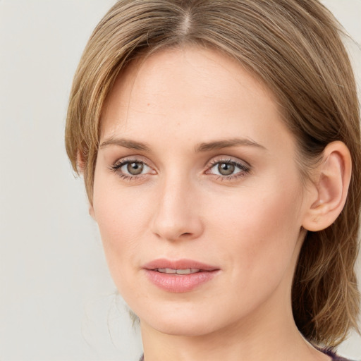 Joyful white young-adult female with long  brown hair and blue eyes