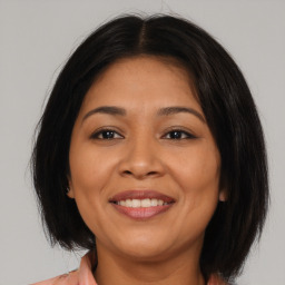 Joyful latino young-adult female with medium  brown hair and brown eyes