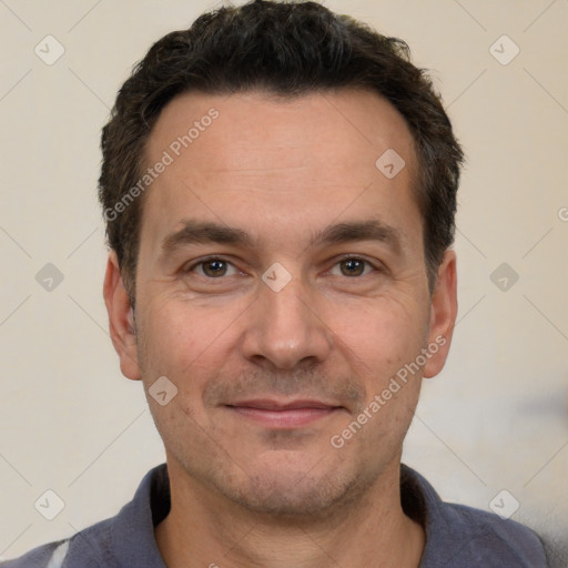 Joyful white adult male with short  black hair and brown eyes