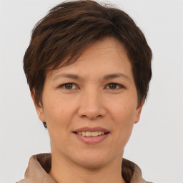 Joyful white adult female with short  brown hair and brown eyes