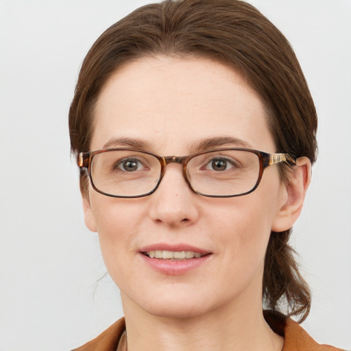 Joyful white young-adult female with short  brown hair and blue eyes