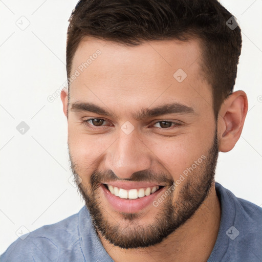 Joyful white young-adult male with short  brown hair and brown eyes