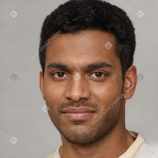 Joyful black young-adult male with short  brown hair and brown eyes