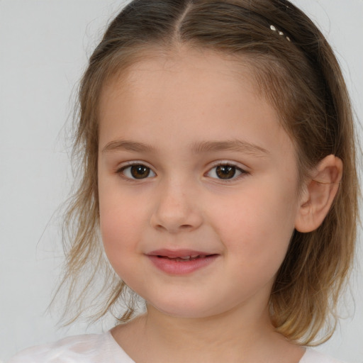 Joyful white child female with medium  brown hair and brown eyes