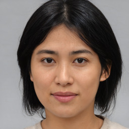 Joyful asian young-adult female with medium  black hair and brown eyes