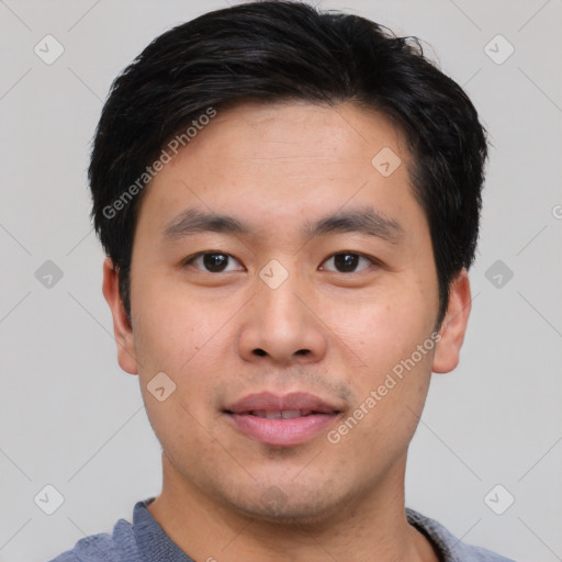 Joyful asian young-adult male with short  black hair and brown eyes