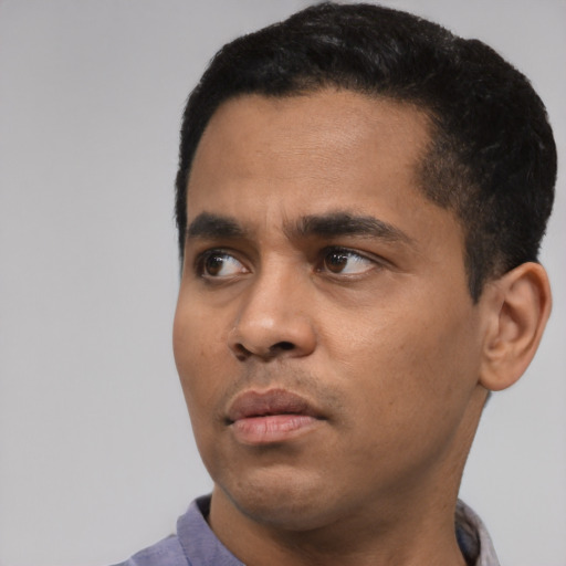Neutral latino young-adult male with short  black hair and brown eyes