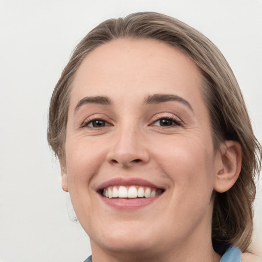 Joyful white young-adult female with medium  brown hair and grey eyes