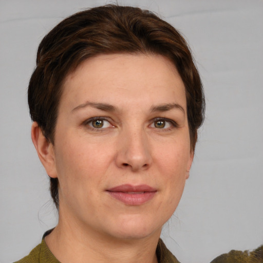 Joyful white adult female with medium  brown hair and grey eyes