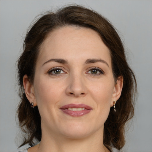 Joyful white adult female with medium  brown hair and brown eyes