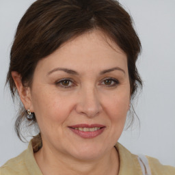 Joyful white adult female with medium  brown hair and brown eyes