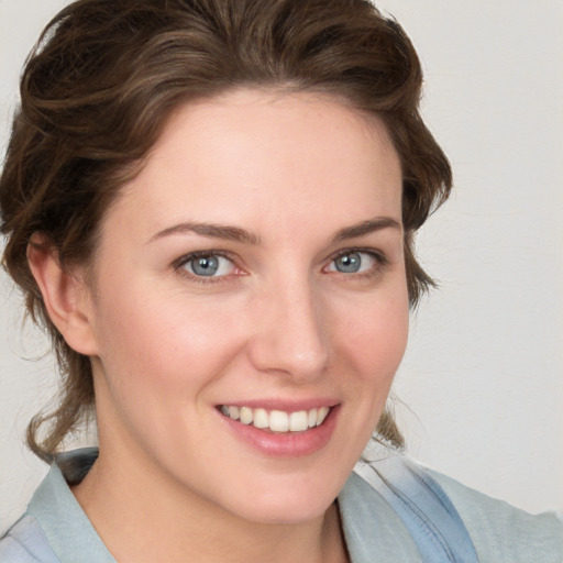 Joyful white young-adult female with medium  brown hair and blue eyes