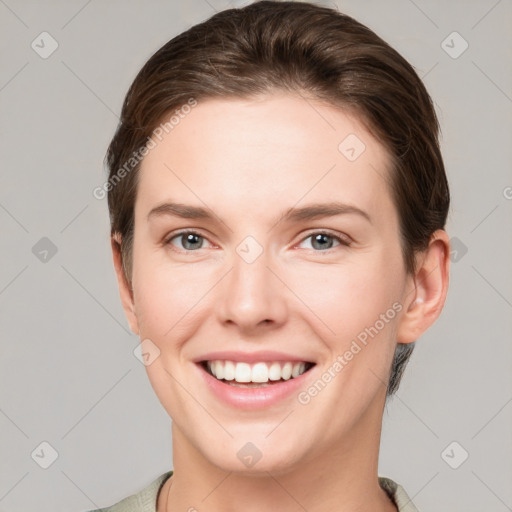 Joyful white young-adult female with short  brown hair and grey eyes