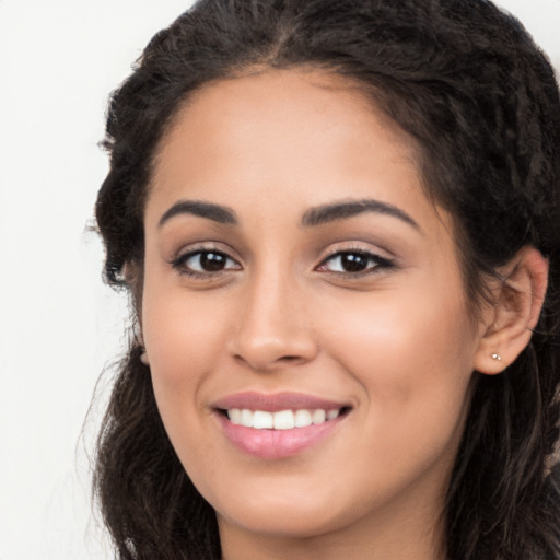 Joyful latino young-adult female with long  brown hair and brown eyes