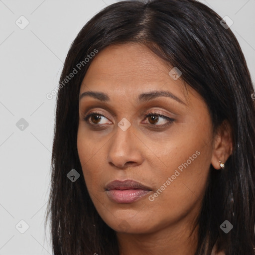 Joyful asian young-adult female with long  brown hair and brown eyes