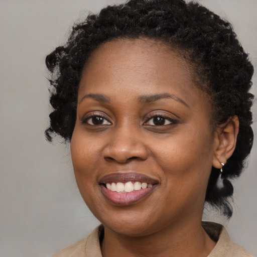 Joyful black young-adult female with medium  brown hair and brown eyes
