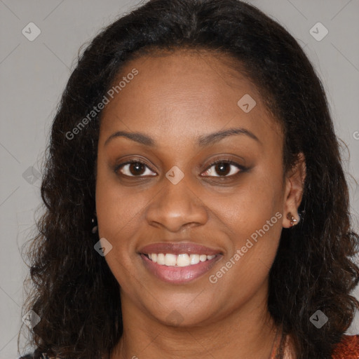 Joyful black young-adult female with long  brown hair and brown eyes