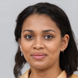 Joyful black young-adult female with medium  brown hair and brown eyes