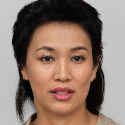 Joyful asian young-adult female with medium  brown hair and brown eyes