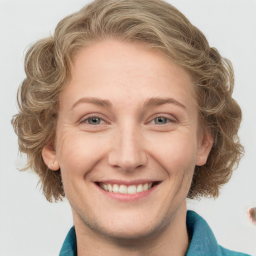 Joyful white young-adult female with medium  brown hair and blue eyes