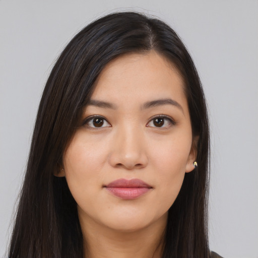 Joyful asian young-adult female with long  black hair and brown eyes