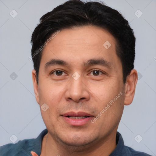 Joyful white adult male with short  black hair and brown eyes