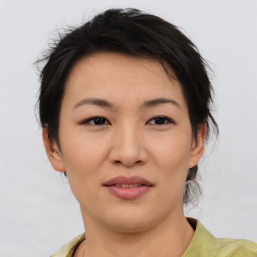Joyful asian young-adult female with short  brown hair and brown eyes
