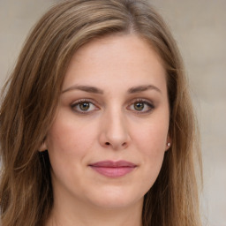 Joyful white young-adult female with long  brown hair and green eyes