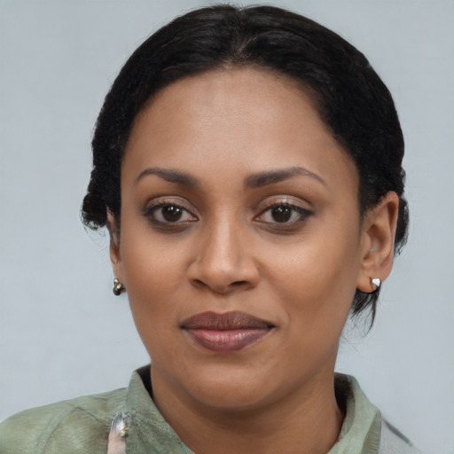 Joyful black young-adult female with short  black hair and brown eyes