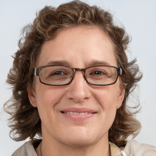 Joyful white adult female with medium  brown hair and blue eyes