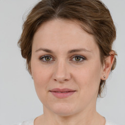 Joyful white young-adult female with medium  brown hair and green eyes