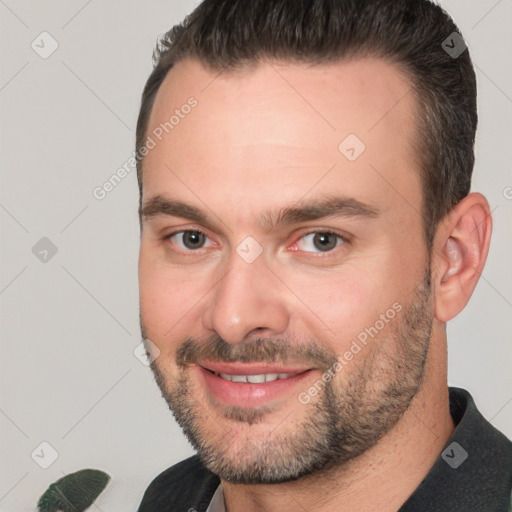 Joyful white adult male with short  brown hair and brown eyes