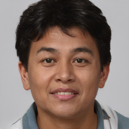 Joyful asian young-adult male with short  brown hair and brown eyes