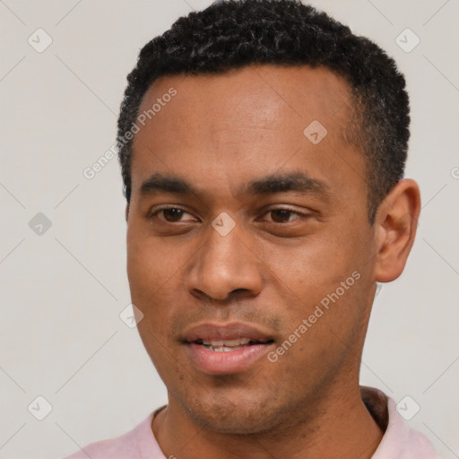 Joyful black young-adult male with short  black hair and brown eyes