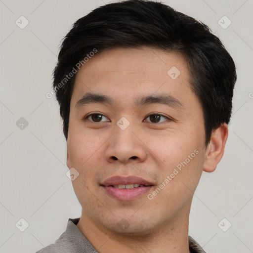 Joyful asian young-adult male with short  brown hair and brown eyes