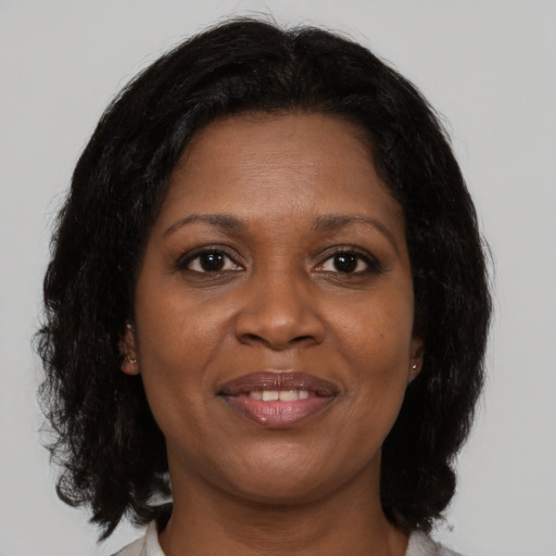 Joyful black young-adult female with medium  brown hair and brown eyes