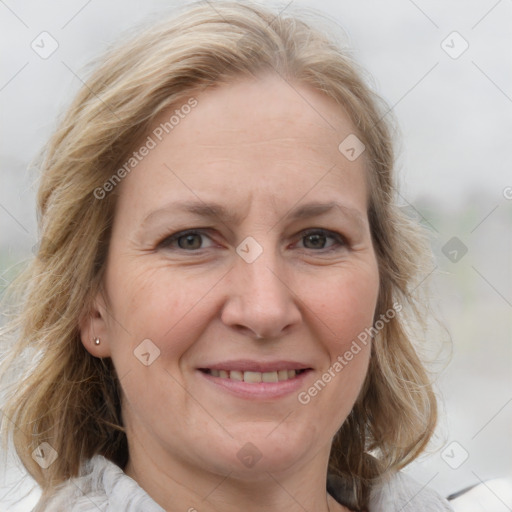 Joyful white adult female with medium  brown hair and blue eyes