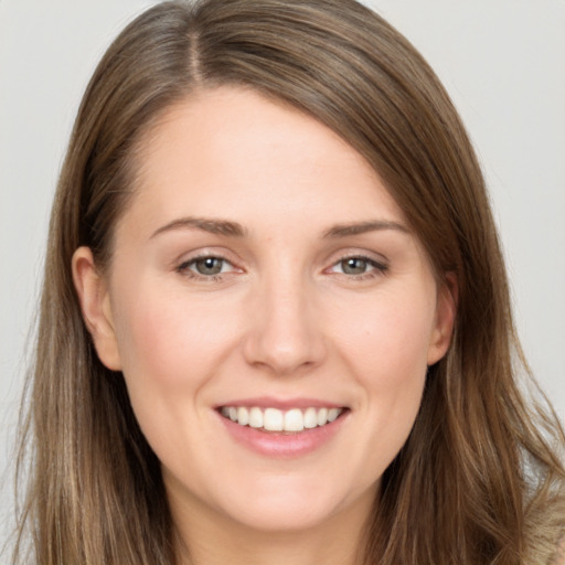 Joyful white young-adult female with long  brown hair and brown eyes