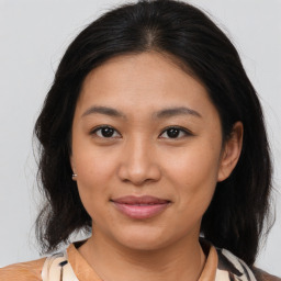 Joyful asian young-adult female with medium  brown hair and brown eyes