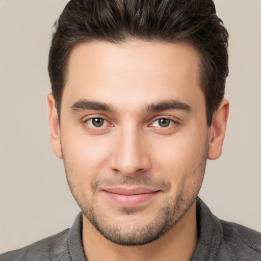 Joyful white young-adult male with short  brown hair and brown eyes