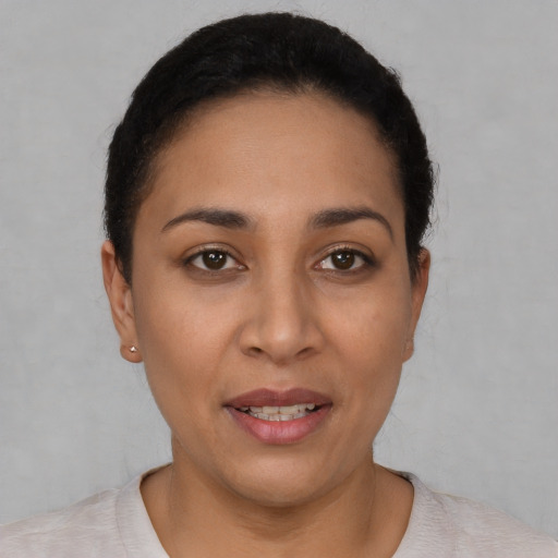 Joyful white young-adult female with short  black hair and brown eyes