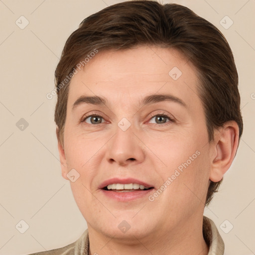 Joyful white adult male with short  brown hair and grey eyes