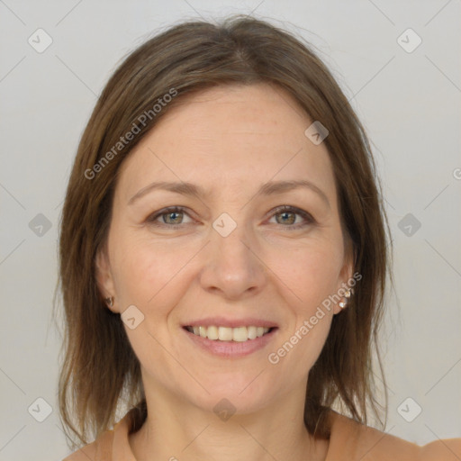 Joyful white adult female with medium  brown hair and grey eyes