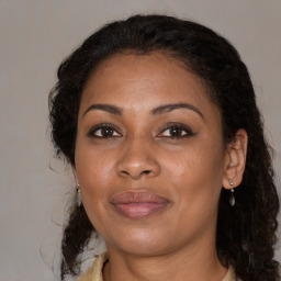 Joyful black adult female with medium  brown hair and brown eyes